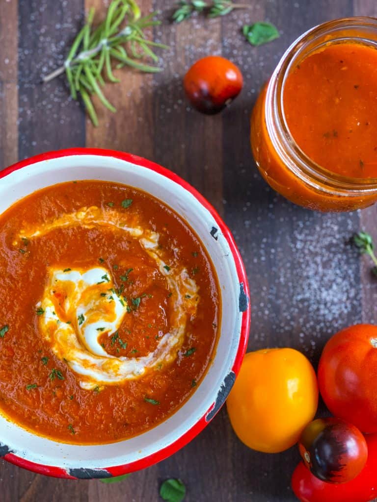 Canned tomato soup in a bowl swirled with sour cream. 