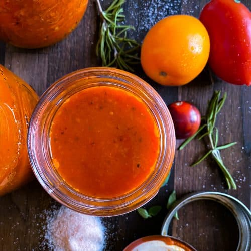 Jar of tomato soup with salt and tomatoes