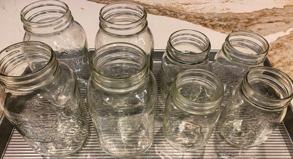 Sterilized jars on a baking sheet.