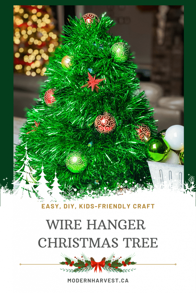 Pinterest image of a green wire hanger Christmas tree adorned with decorative balls and stars.