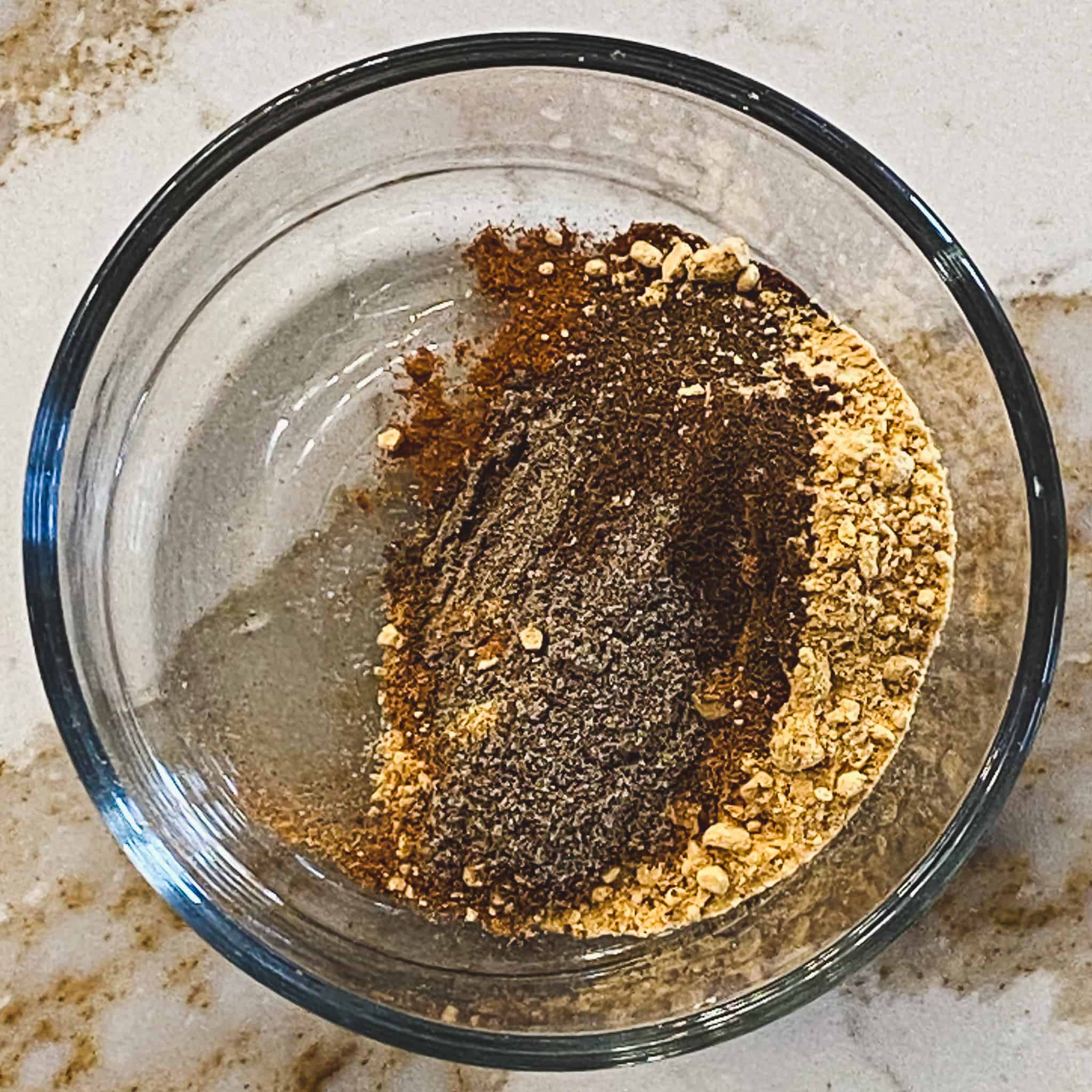 chai spices in a glass bowl, showing each spice.