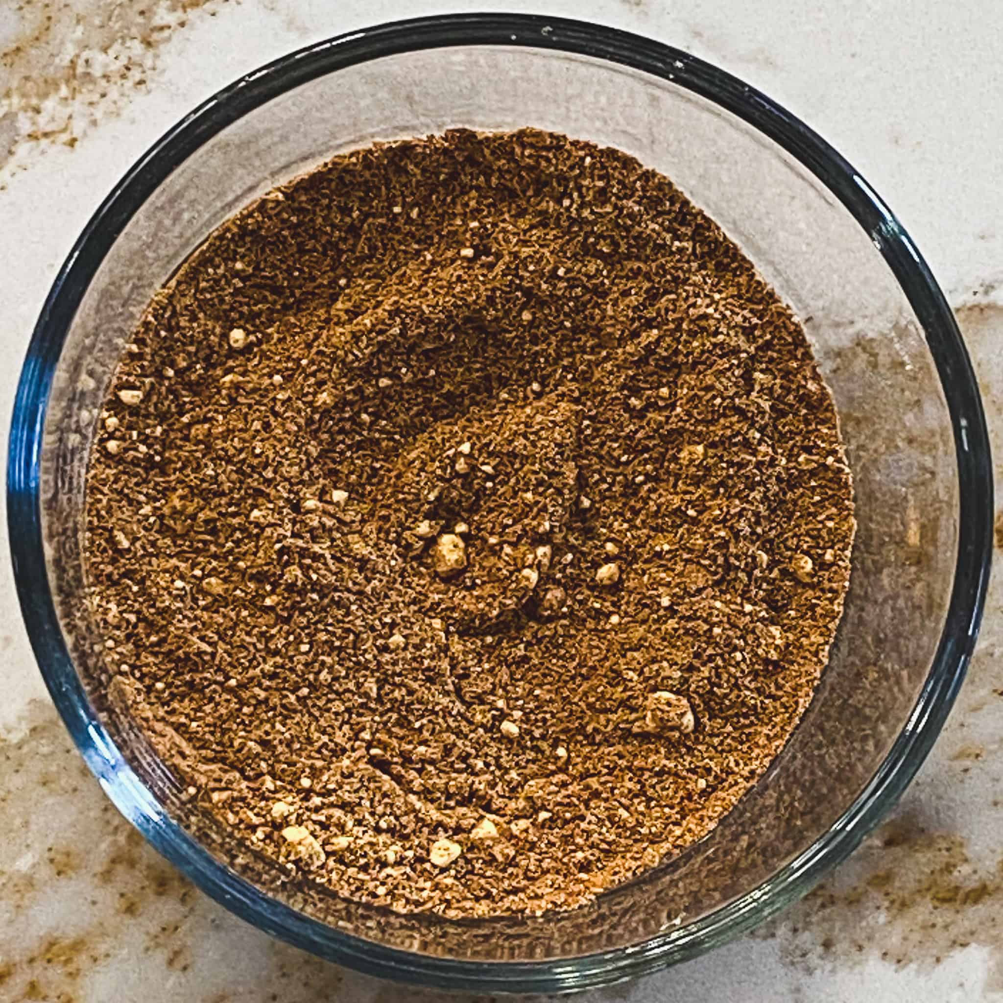 Chai spices mixed in a glass bowl.