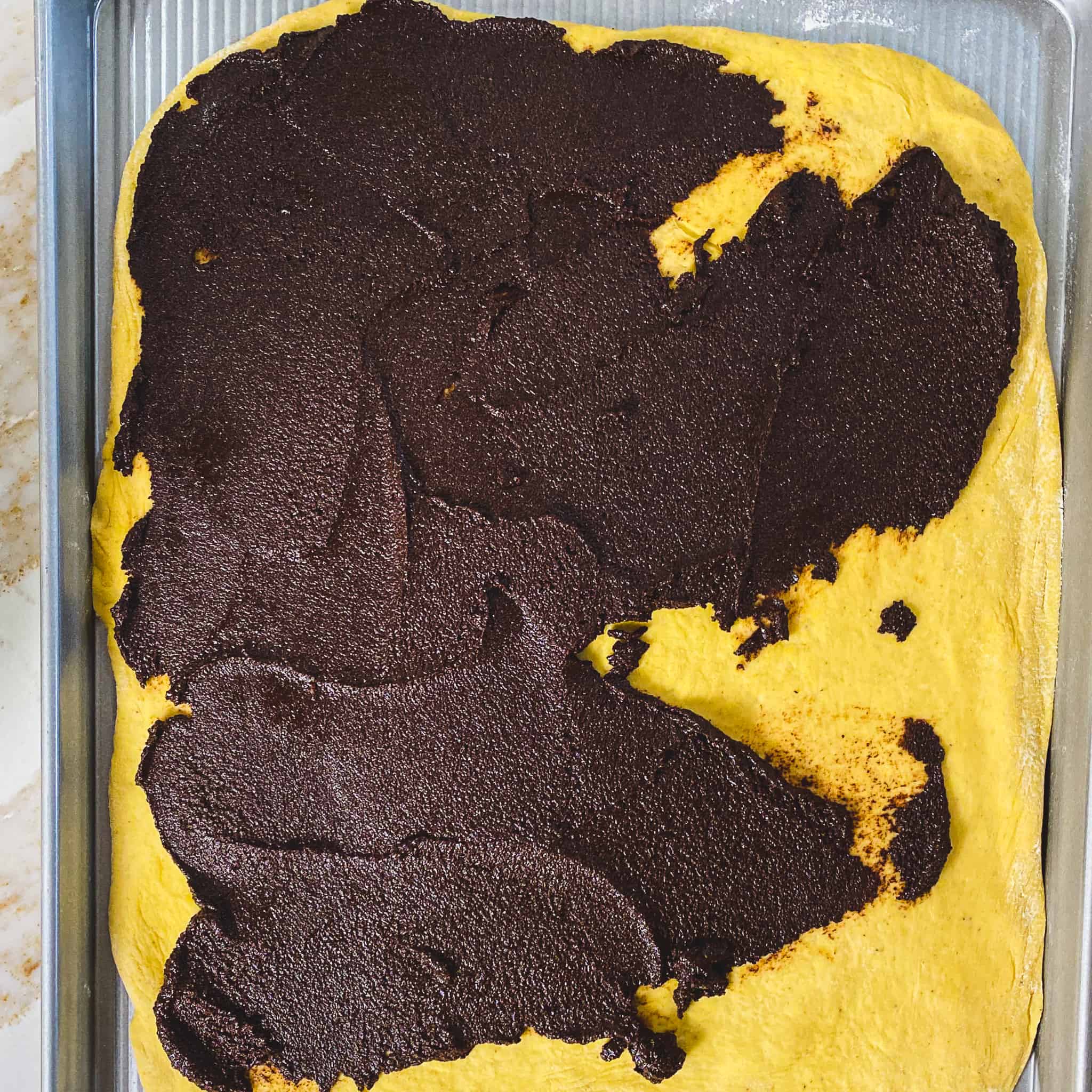 Chocolate filling smeared on top of pumpkin babka dough.