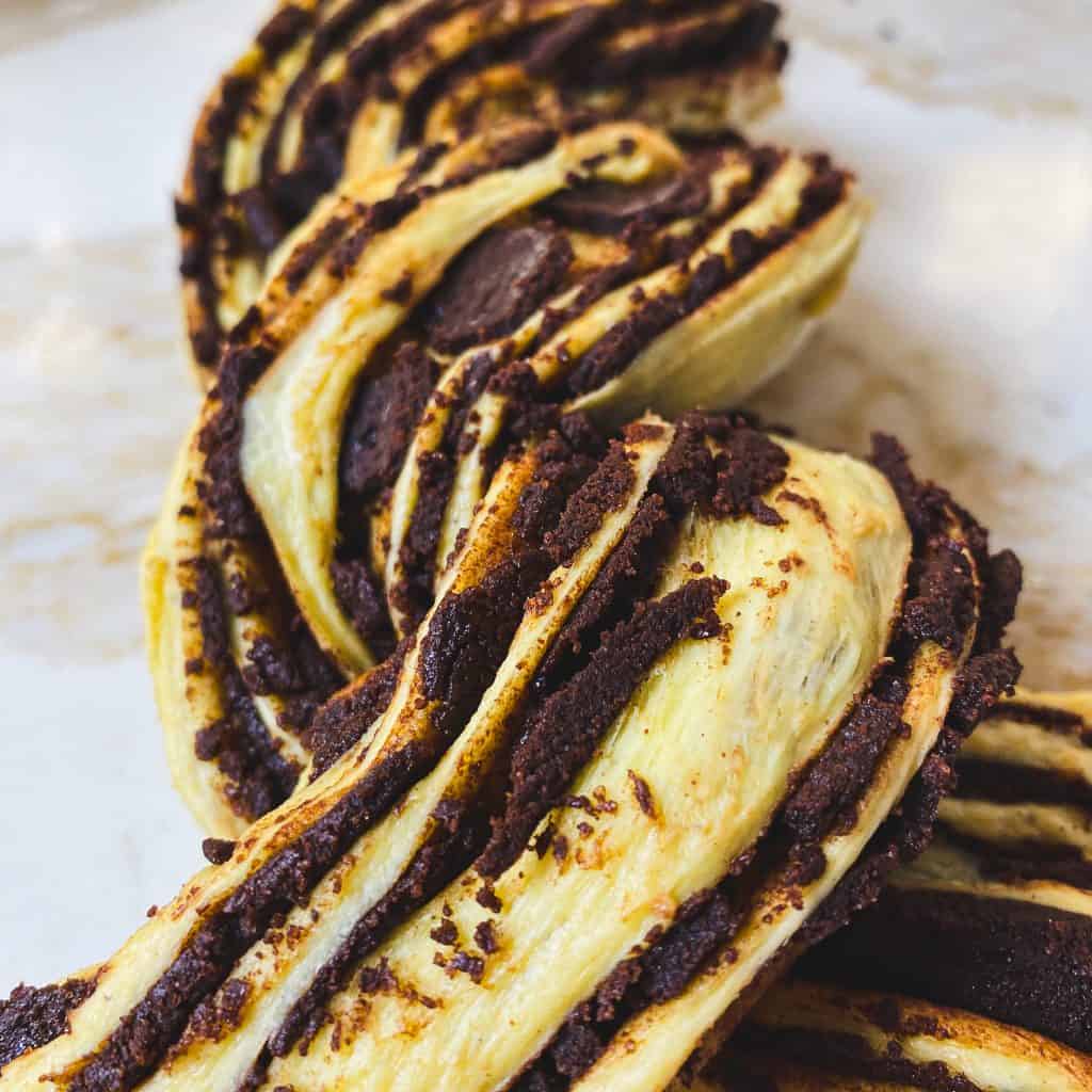Close up of the twisted chocolate pumpkin babka with crumbling chocolate.
