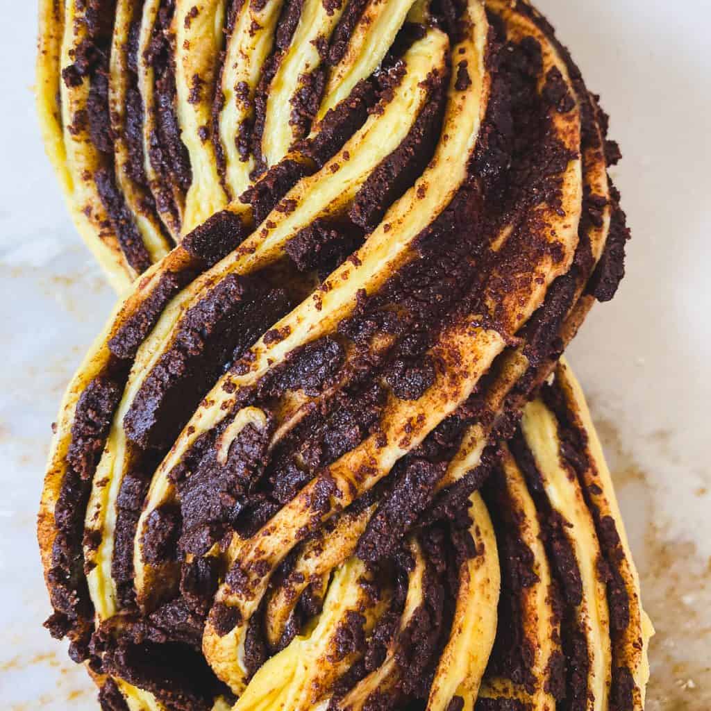 Close up of the twisted chocolate pumpkin babka with crumbling chocolate.