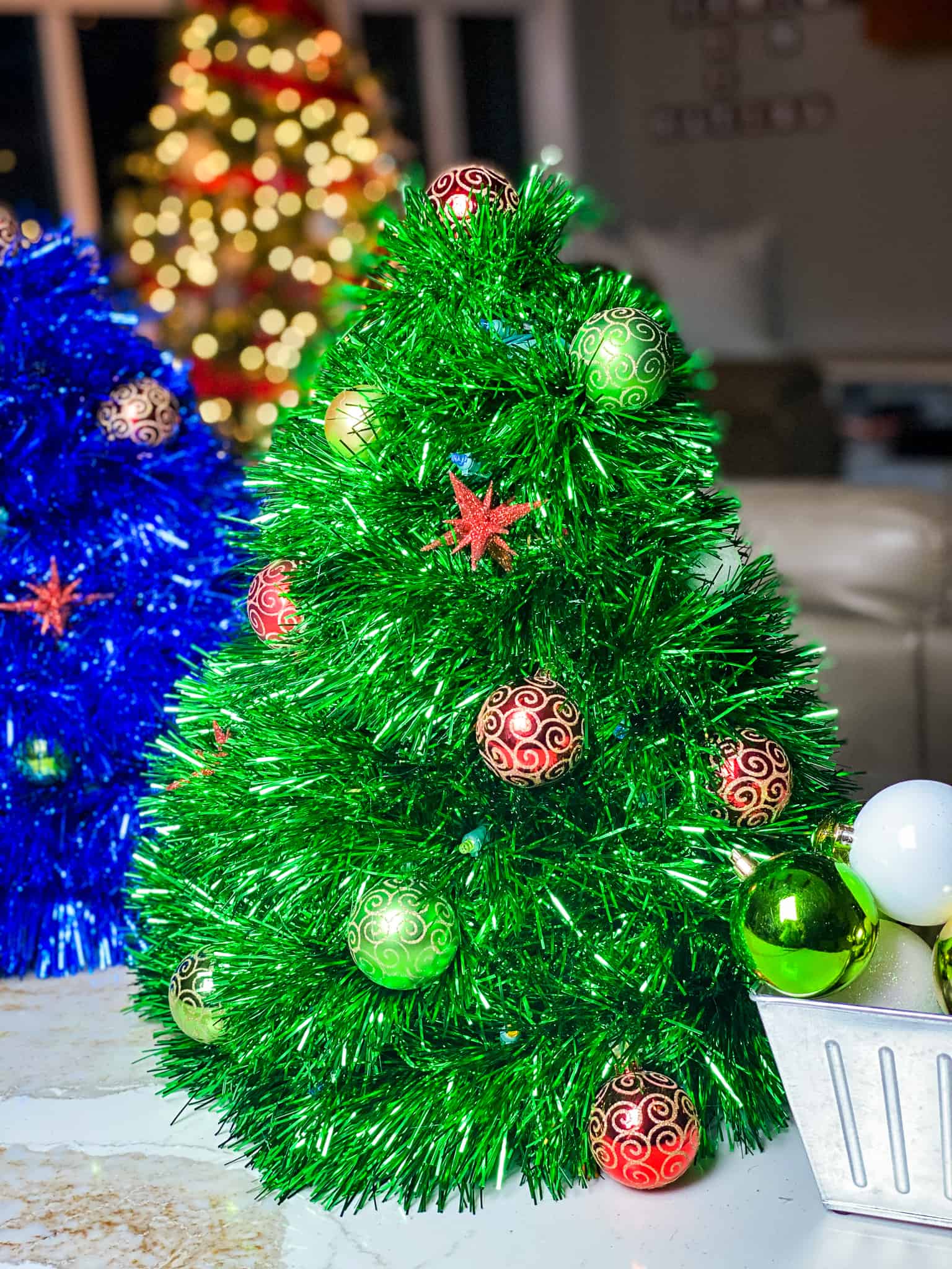 Blue and Green wire hanger Christmas trees sitting on the counter. Beautiful and easy decorations. Mini trees are the perfect addition to your Christmas decor.