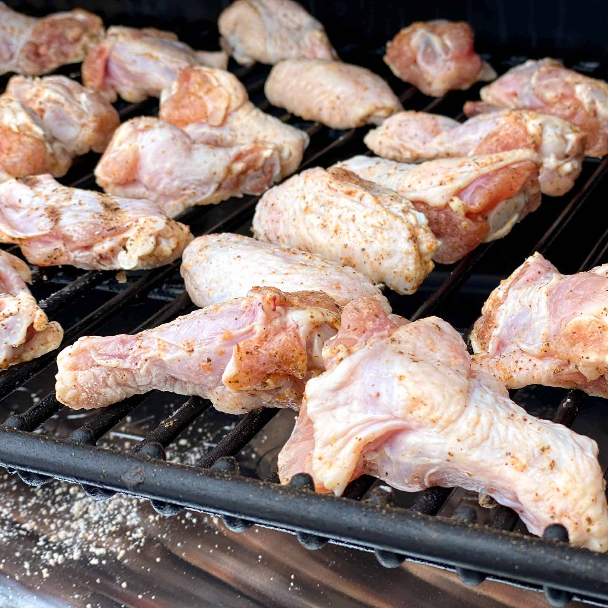 Raw chicken wings on a traeger pellet grill.