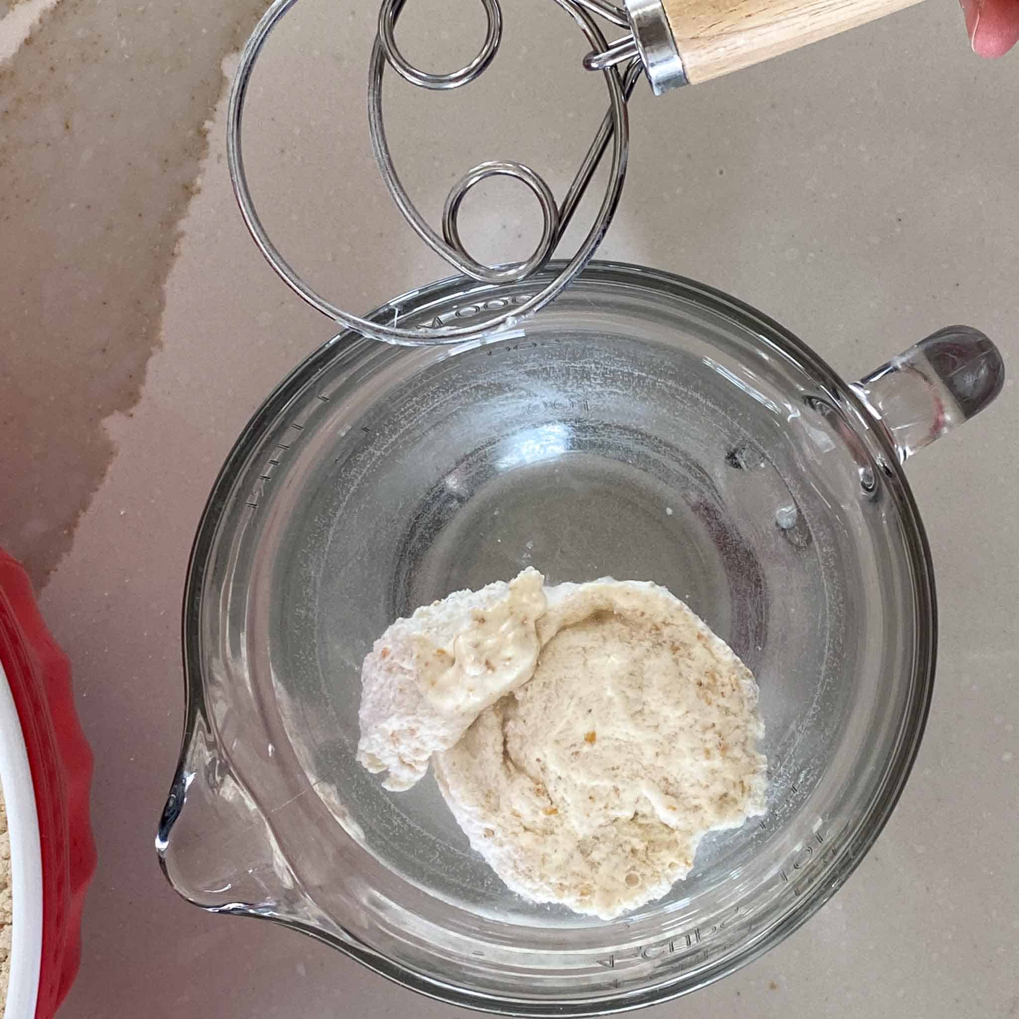 Whole grain sourdough starter floating in water.
