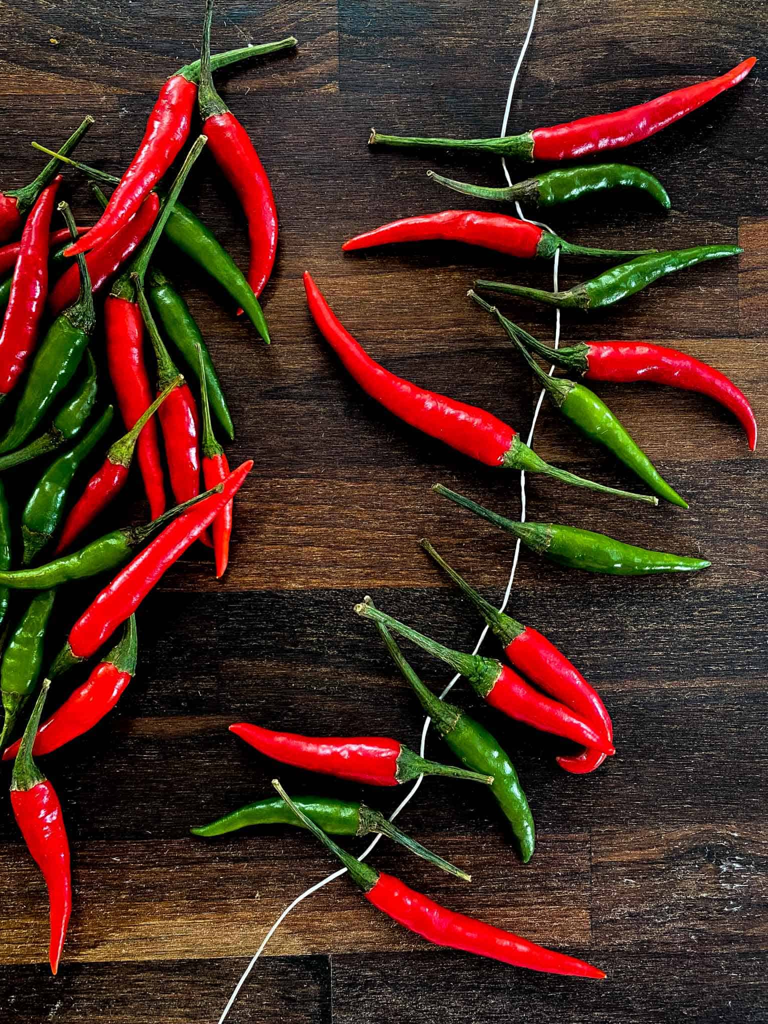 Chili peppers on a string, ready to be air dried.