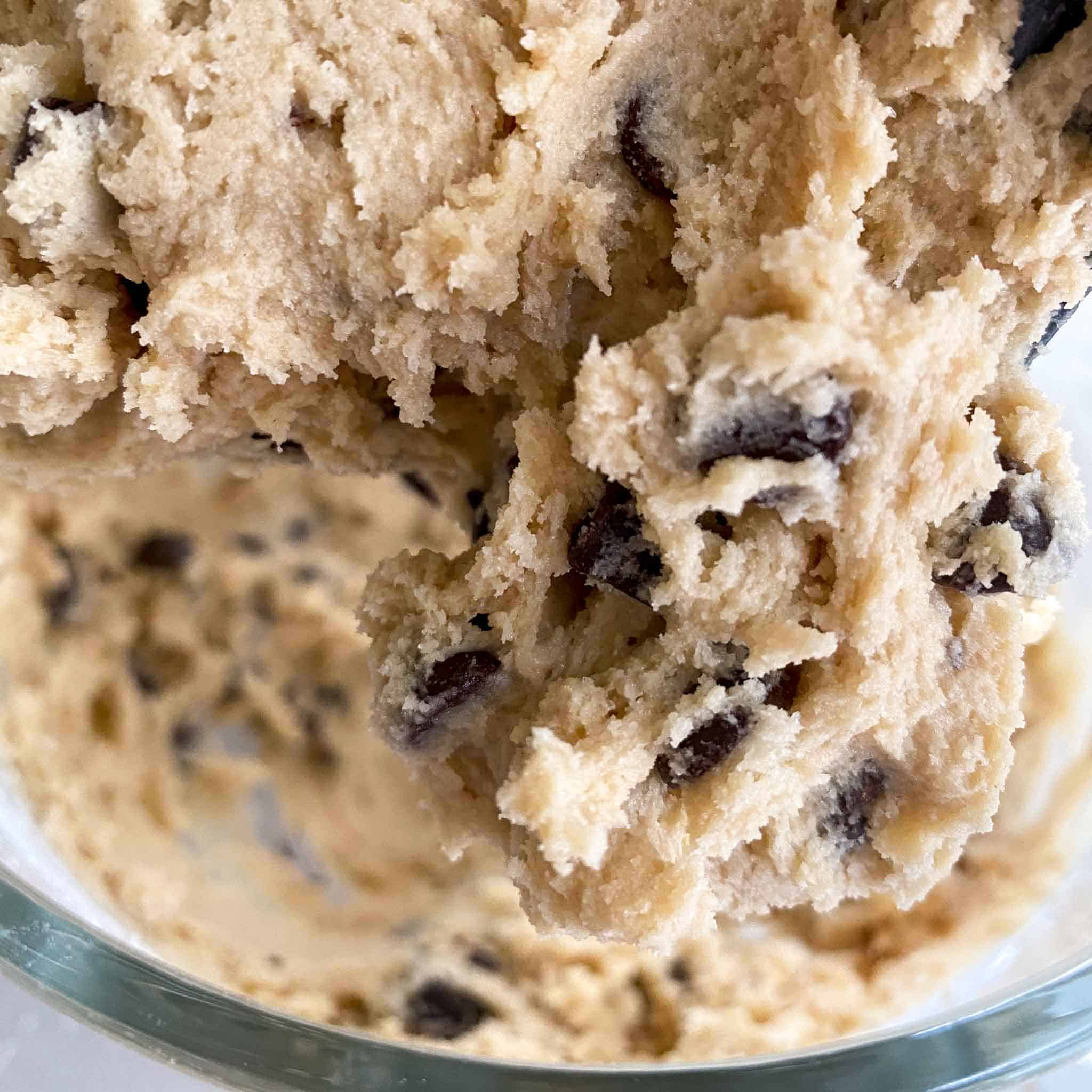 A close up view of the chocolate chip cookie dough without butter.