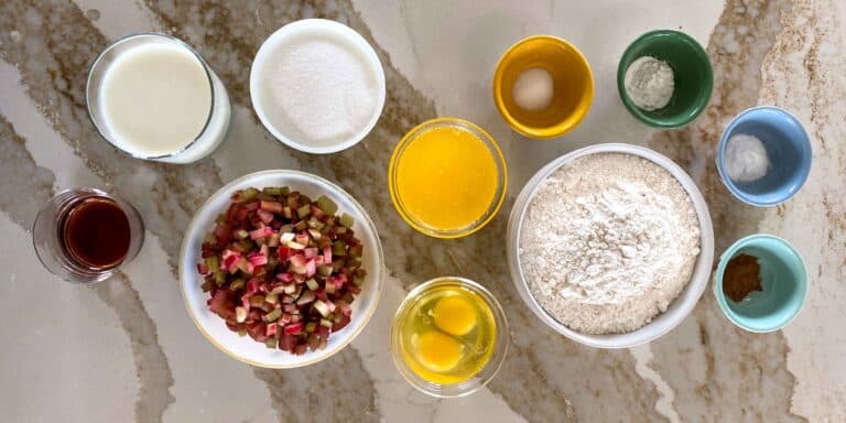 Key ingredients laid out for rhubarb buttermilk muffins including diced rhubarb flour, and other ingredients.