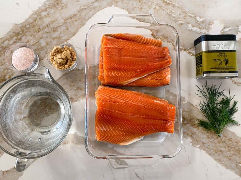 Key ingredients for smoked trout fillets including trout, dry rub, water, brown sugar, dill, salt.