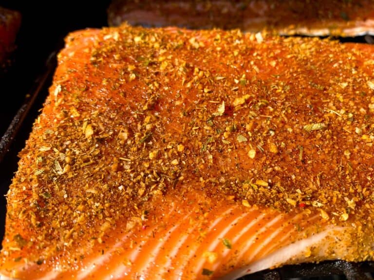 Raw trout fillet ready to be smoked with fin and feather dry rub on top.