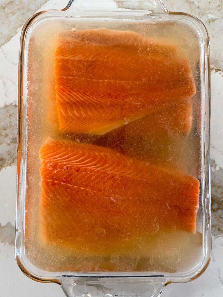 Trout fillets in a simple brine ready to be smoked.