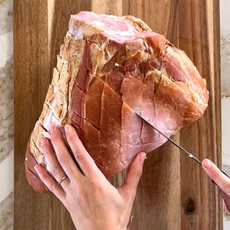 Cross hatch scoring a large bone in ham before smoking.