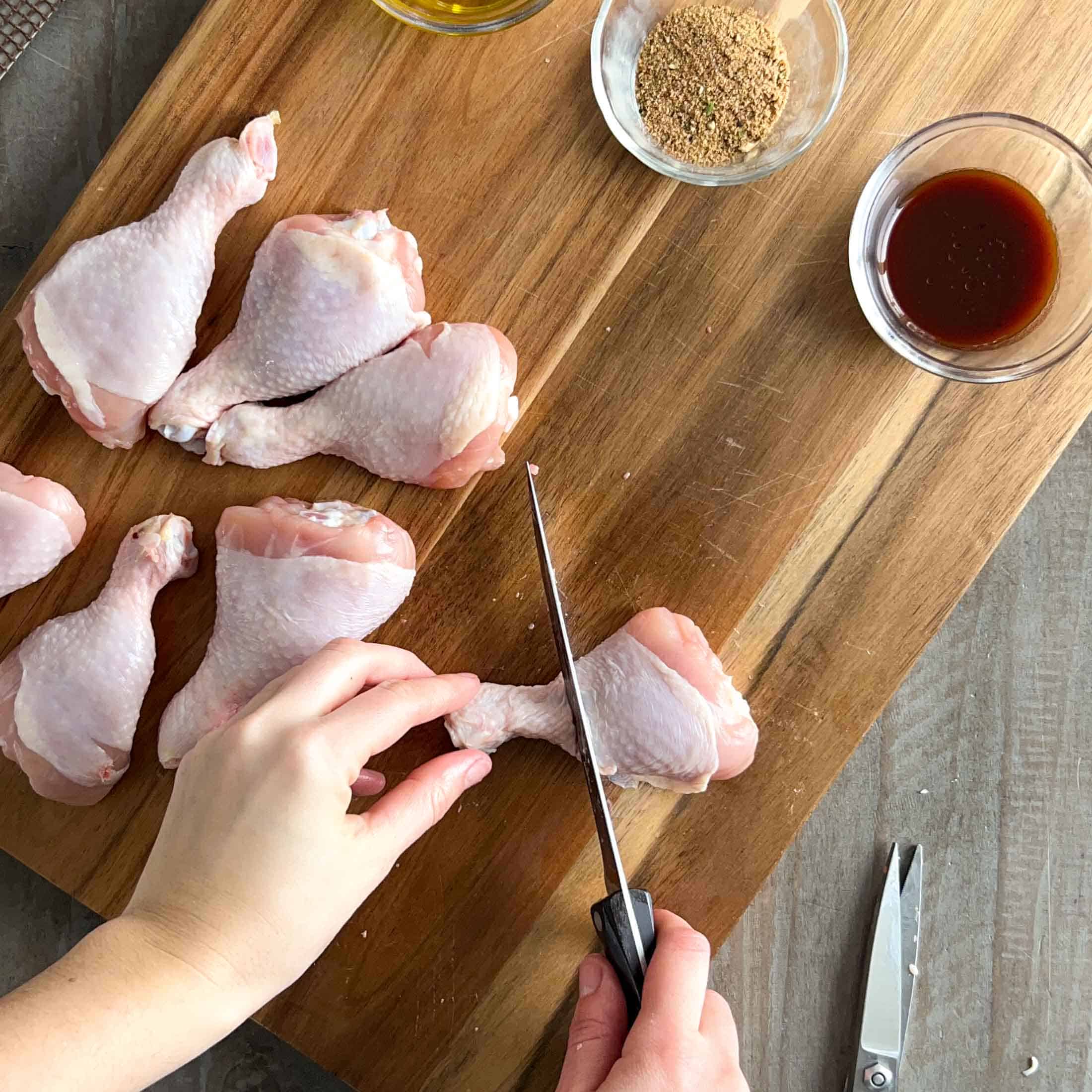 Cutting the top of a chicken drumstick off to create a handle.