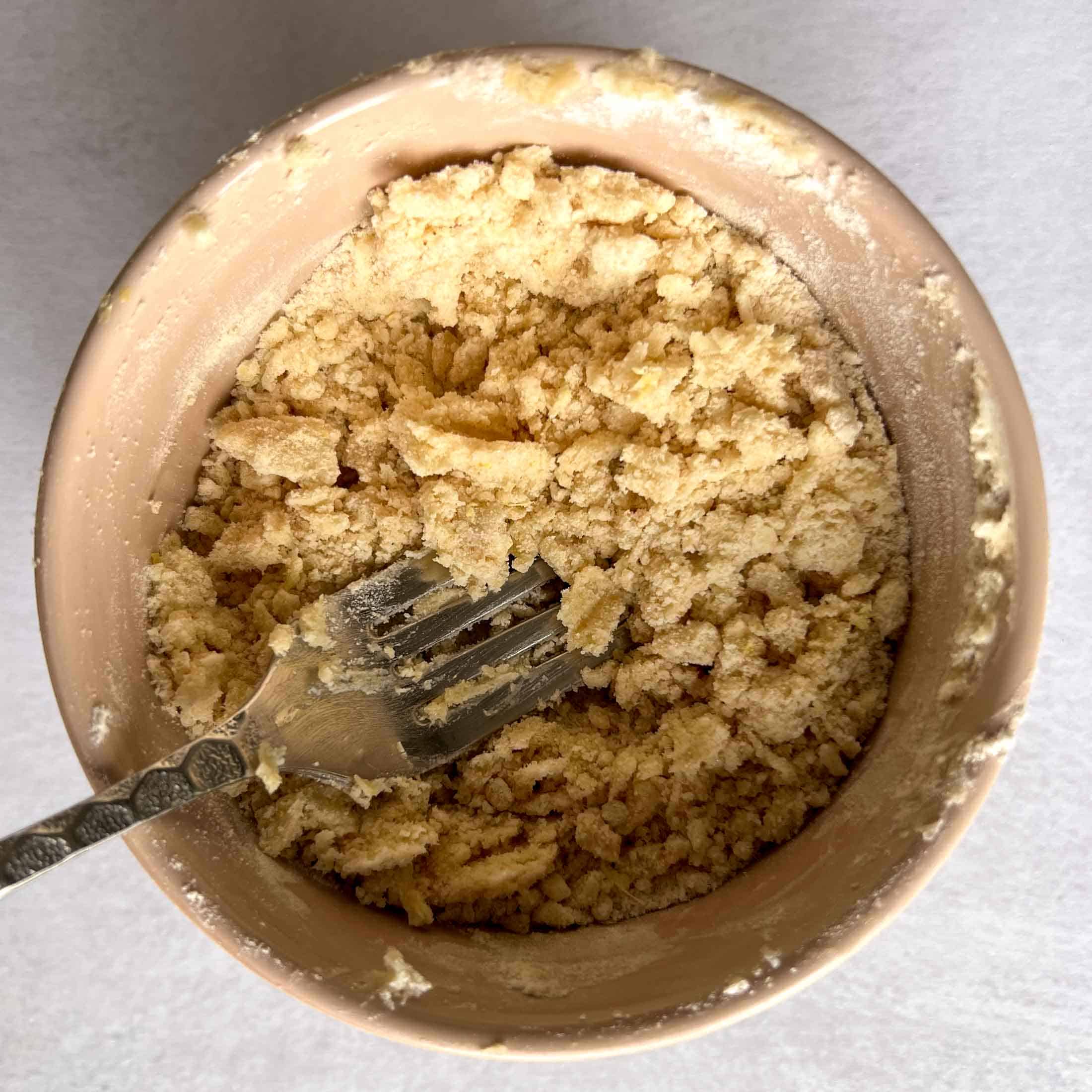 Mixed streusel topping with a fork in a bowl.