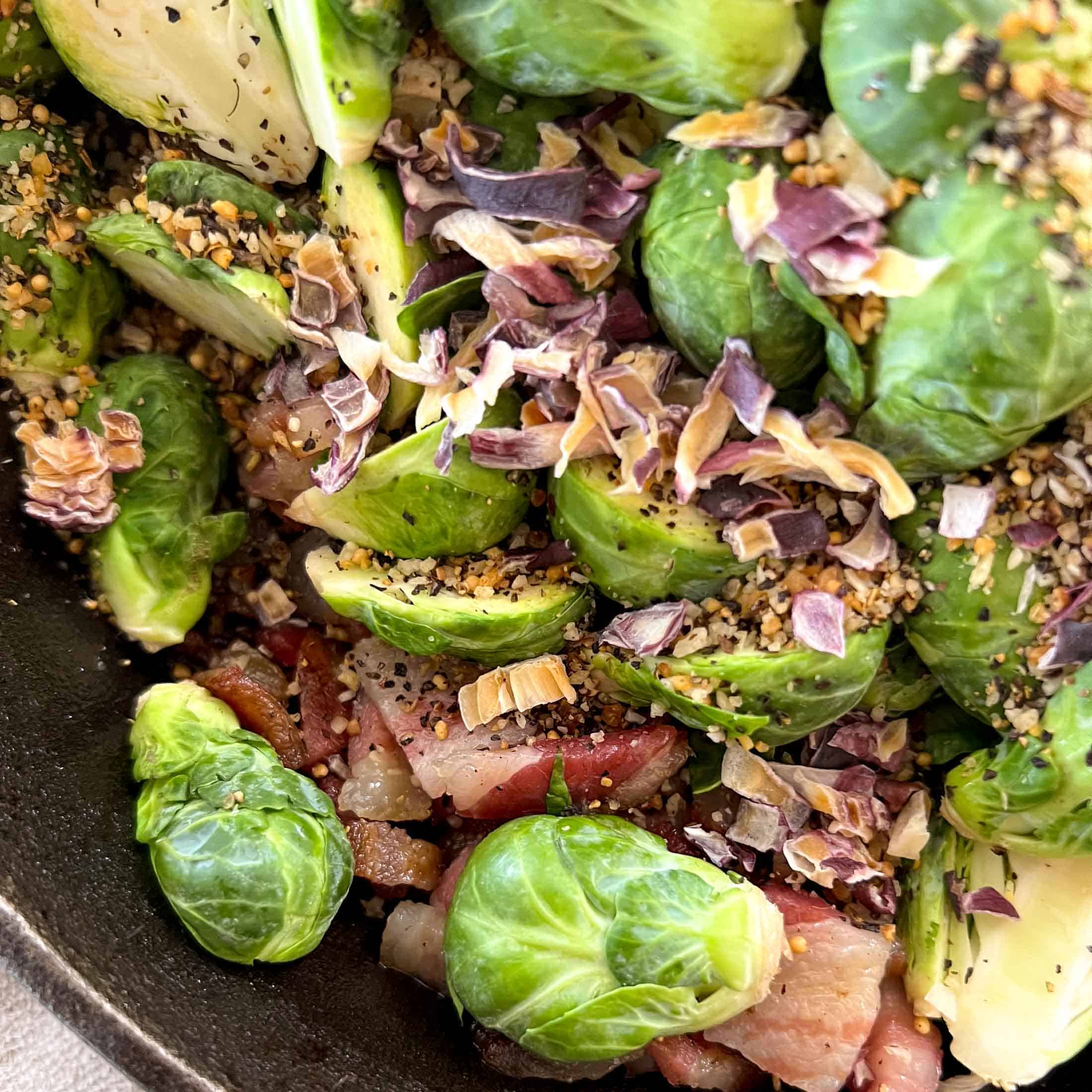 Dehydrated onions and steak spice sprinkled on top of raw brussel sprouts and crispy bacon.
