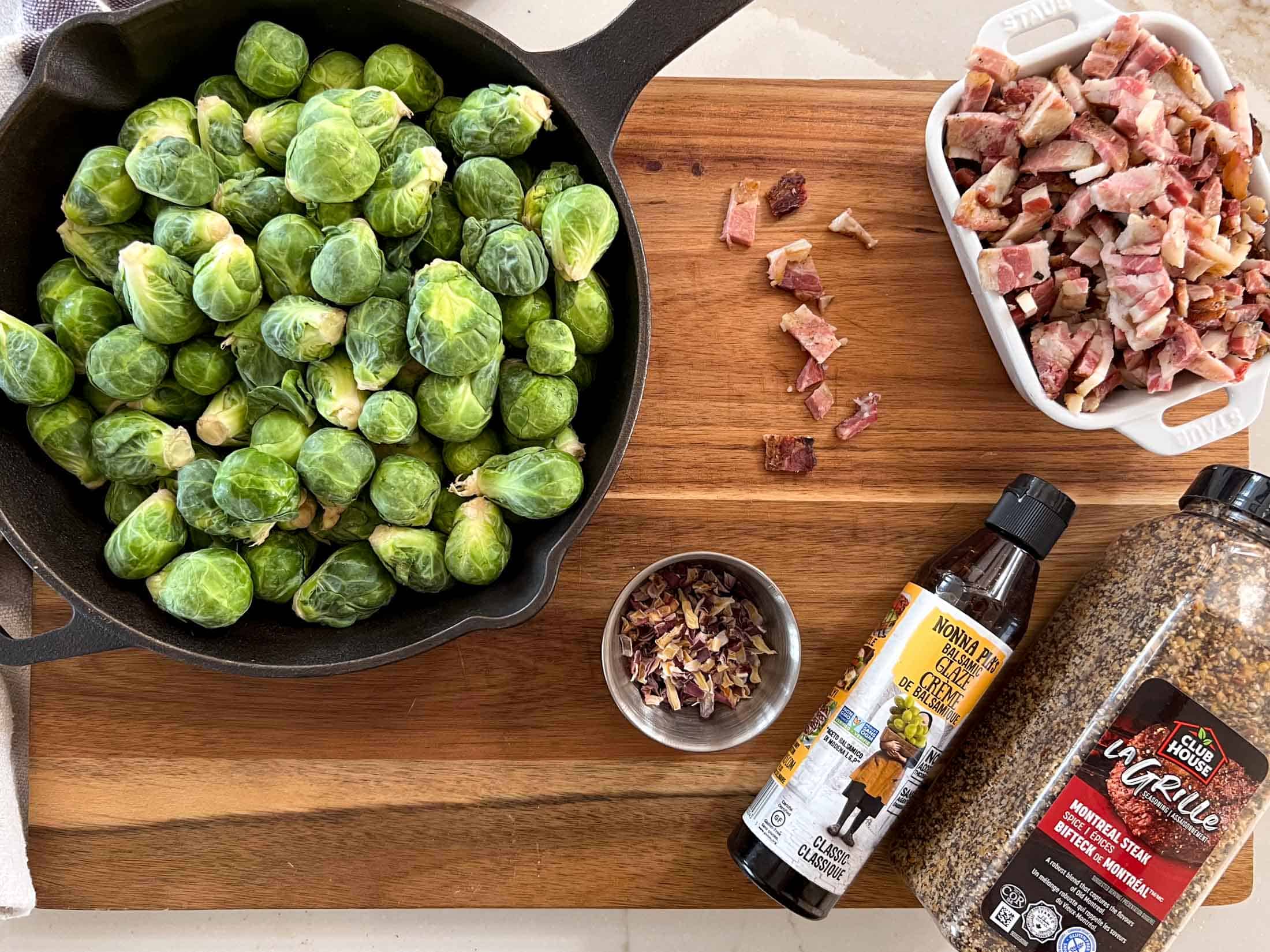 Raw brussel sprouts in a cast iron skillet, cooked bacon, dried onions, balsamic glaze and montreal steak spice.