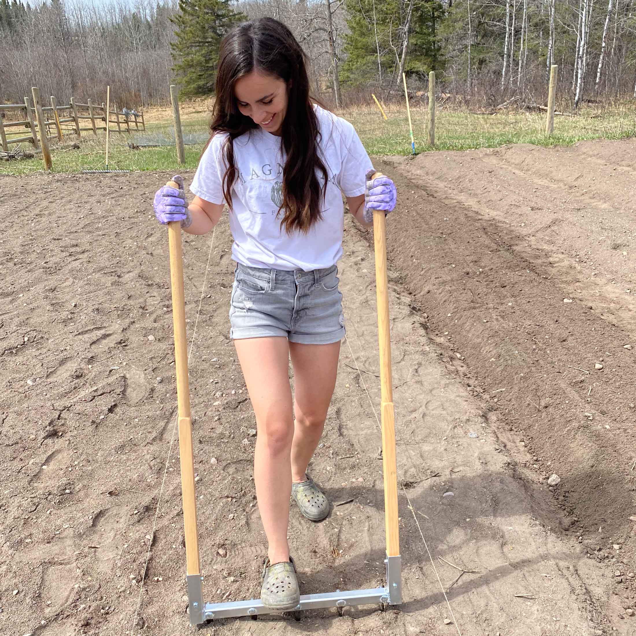 Kate stepping on a broad fork on a newly shaped 30-inch garden row.