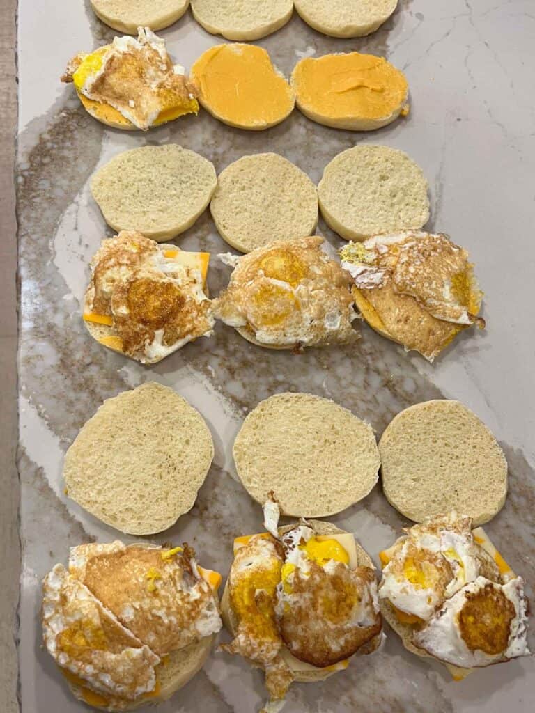 Sourdough english muffins being made into breakfast sandwiches.